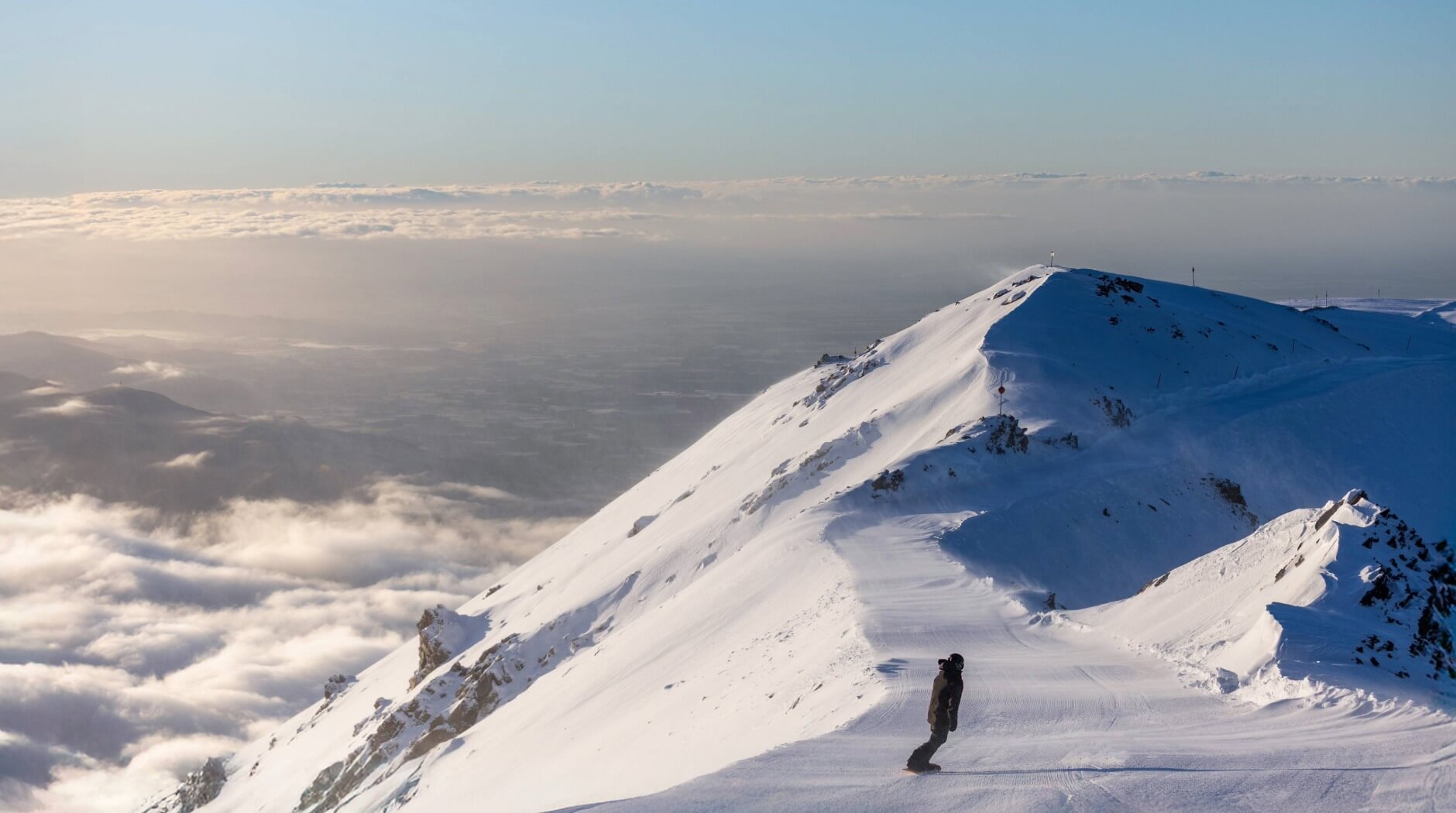 Snowboarder on a snowy mountain slope at Mt Hutt