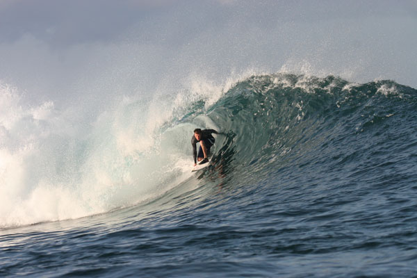 Local surf instructor on the beach with surfboards