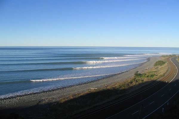 Surfers riding waves along the coast